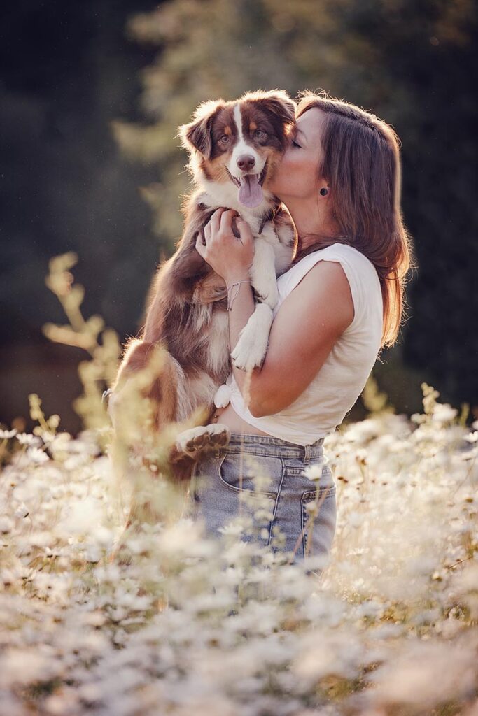 Woman and brown Australian Shepherd
